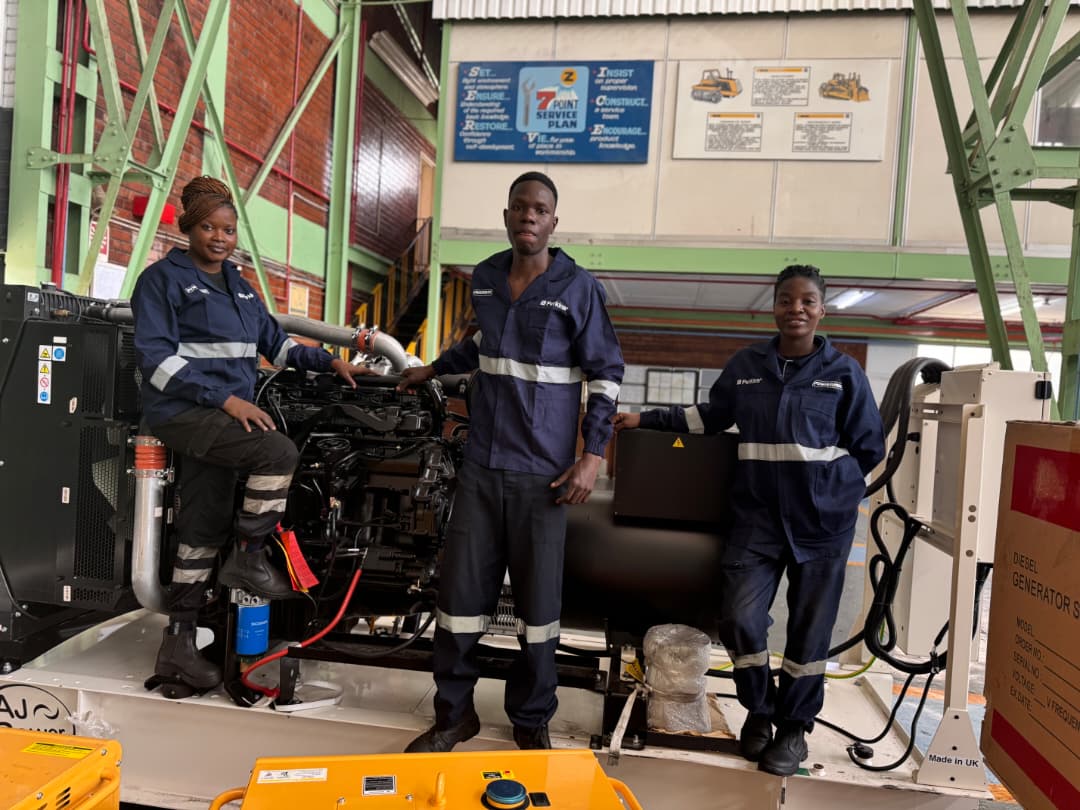 Powermec service technicians beside a generator set